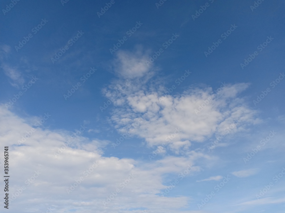 white clouds against a blue sky background