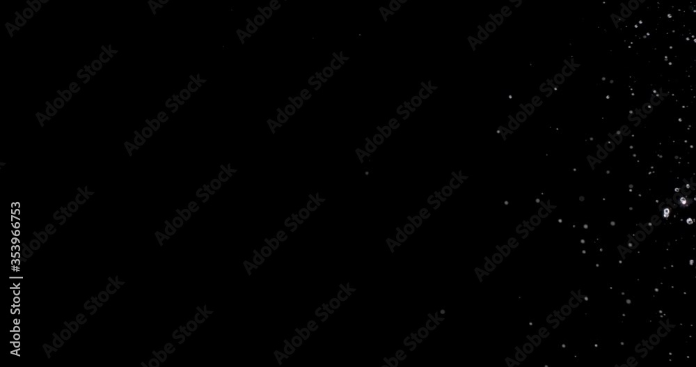 burst of water coming from the right side of the black background. burst of water coming from the right side of the black background.