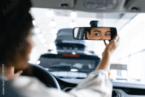 Lady Adjusting Mirror Testing Vehicle Sitting In Auto Driver's Seat © Prostock-studio