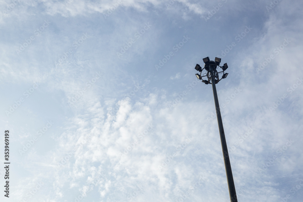 Pillar spotlight outdoor on blue sky background white fluffy clouds on summer day for sport concept