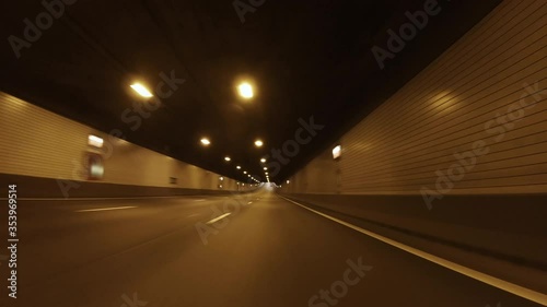 POV, Driving Plate - car driving through a tunnel with daylight at the end of it. Day shot.