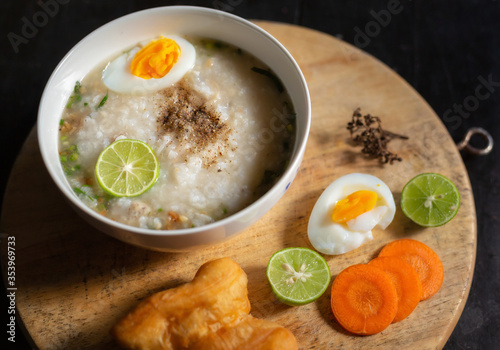 Asian congee with minced pork in white bowl.