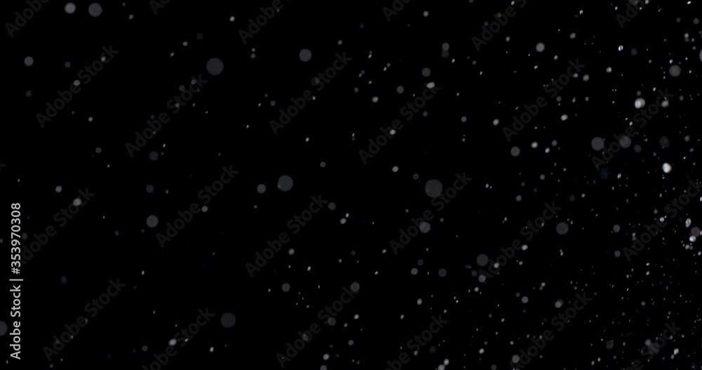 water bubble bursting against a black background. water bubble bursting against a black background.