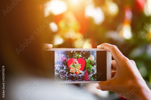 Woman holding mobile phone on blur background