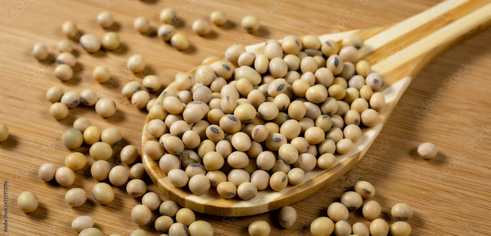 Soybeans in a wooden spoon on the table Soybeans in a wooden spoon on the table