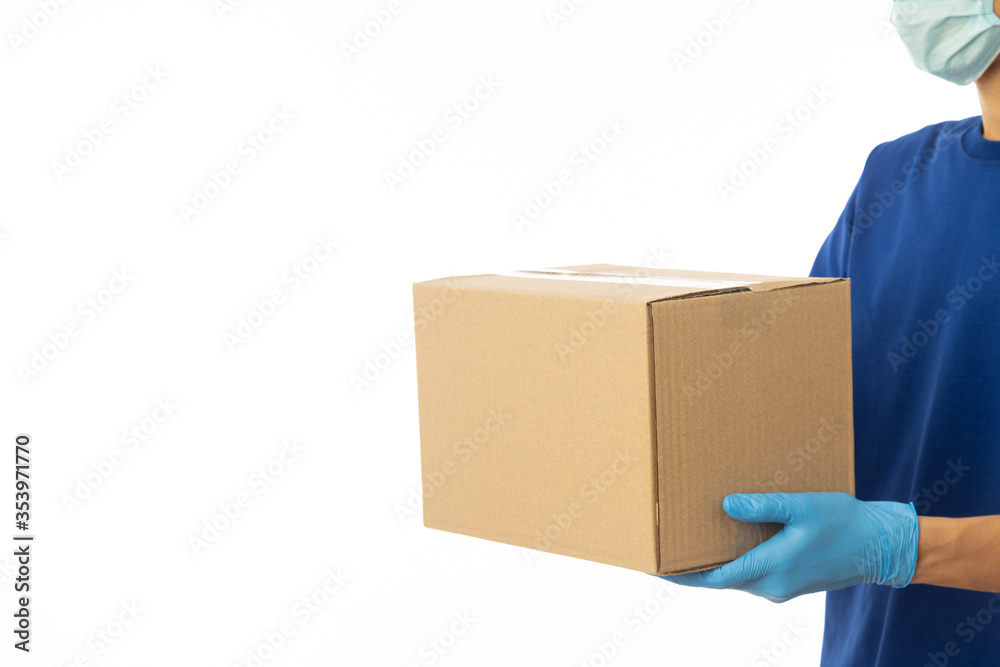 Delivery man hand in medical gloves and wearing mask holding cardboard boxes isolated on white background, Delivery service concept. Delivery man hand in medical gloves and wearing mask holding cardboard boxes isolated on white background, Delivery service concept.