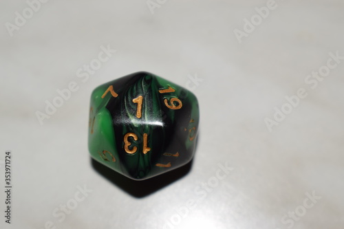 Twenty sided green and black dice showing the number photo