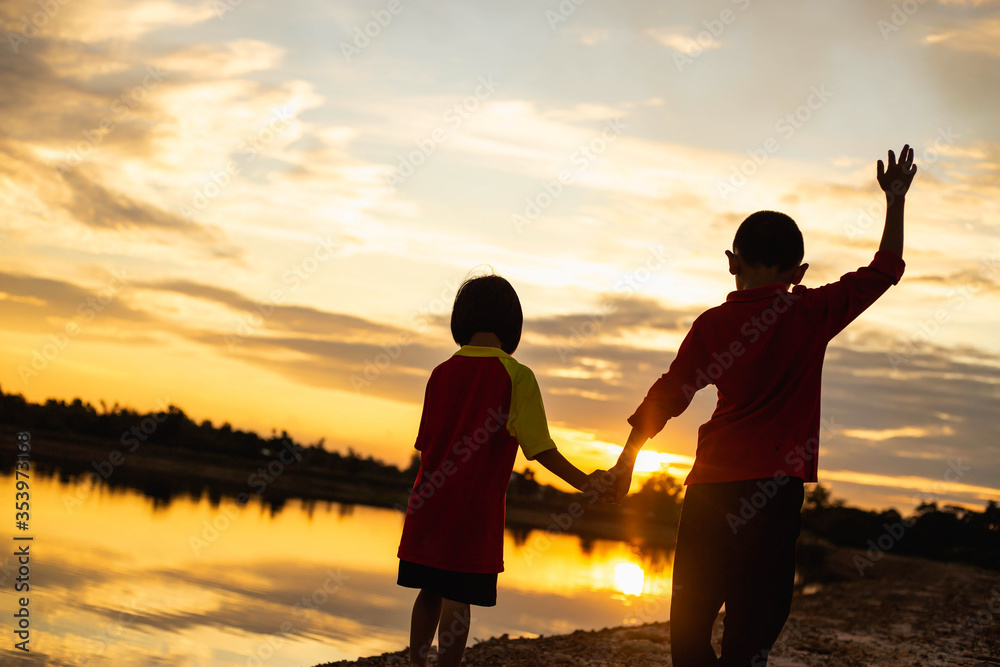 Fototapeta premium kid silhouette,Moments of the child's joy. On the Nature sunset