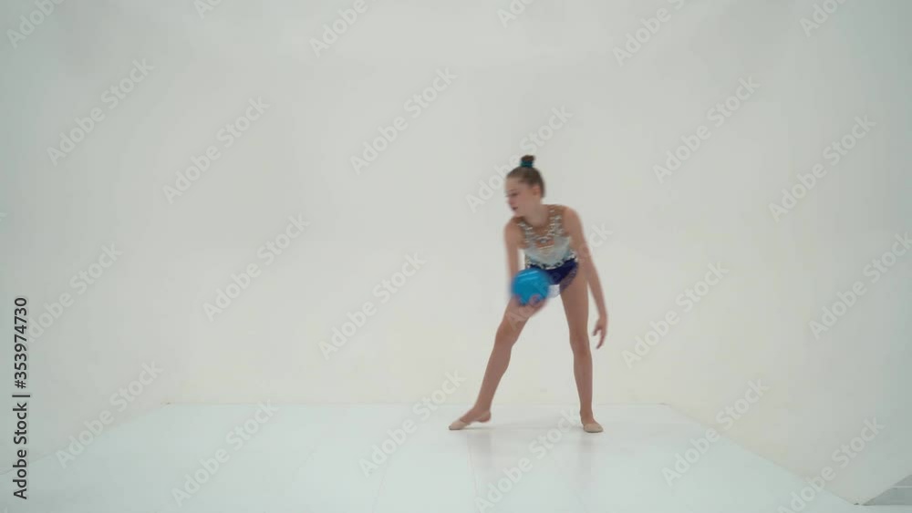 Girl gymnast performs exercises with the ball.