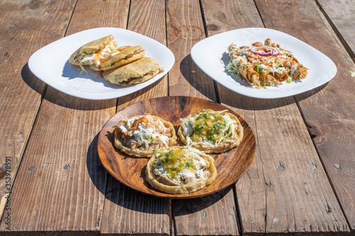 variety of Mexican food dishes. sopes, tacos, gorditas stuffed. photo