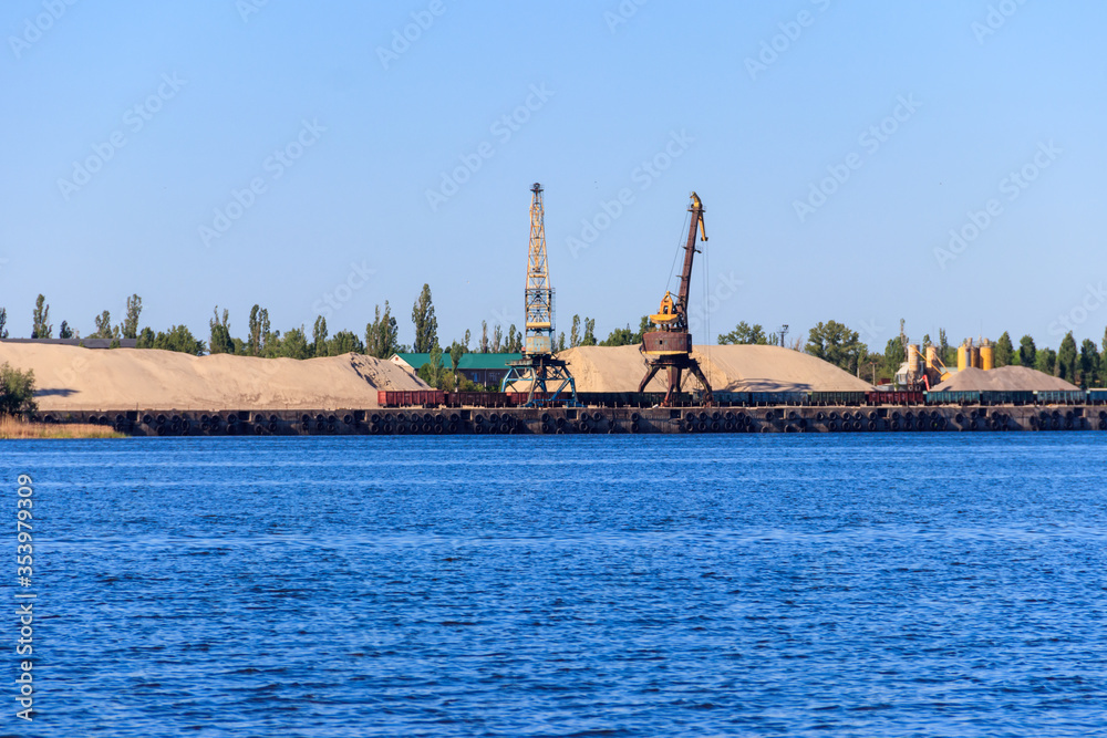 Hoisting cranes at cargo port on the Dnieper river in Kremenchug, Ukraine