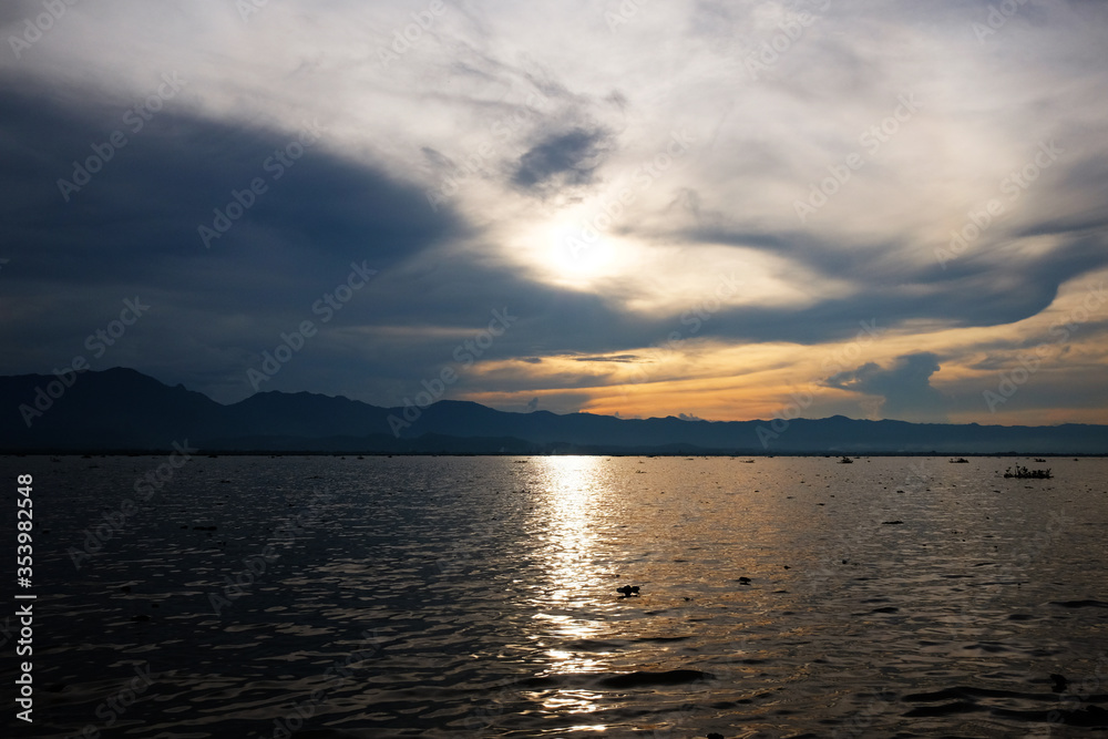 Destination of Beautiful Silhouette and twilight of sunset Reflected light on the water surface and glittering waves in the River Destination of Beautiful Silhouette and twilight of sunset Reflected light on the water surface and glittering waves in the River