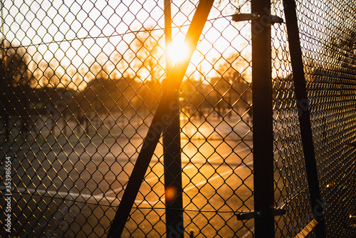 Sunset through a wire fence 02