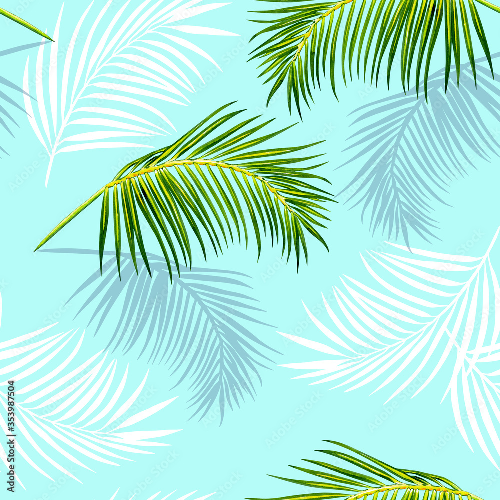 Tropical palm print on a blue background. Palm leaves seamless pattern