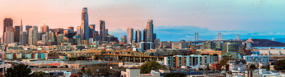 San Francisco city skyline panorama after sunset with city lights, the Bay Bridge and highway leading into the city