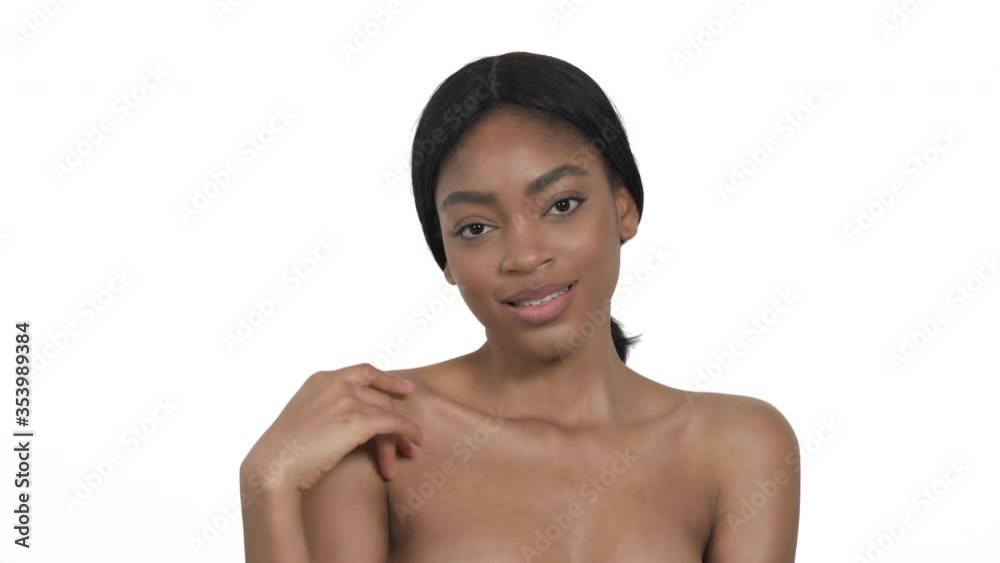 Slim naked woman is gently touching her decollete with hand in seductive manner. Erotic concept. Isolated, on white background Slim naked woman is gently touching her decollete with hand in seductive manner. Erotic concept. Isolated, on white background
