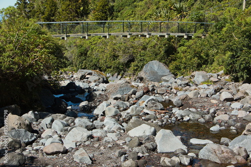 Suspension bridge on Wilkies Pool Loop Track in Egmont National Park,Taranaki region on North Island of New Zealand 
 photo