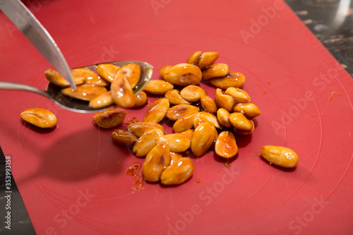 Making almond candied pralines in caramel served. photo