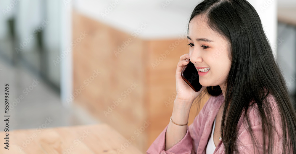 Charming woman calling with cell telephone while sitting in coffee shop. Charming woman calling with cell telephone while sitting in coffee shop.
