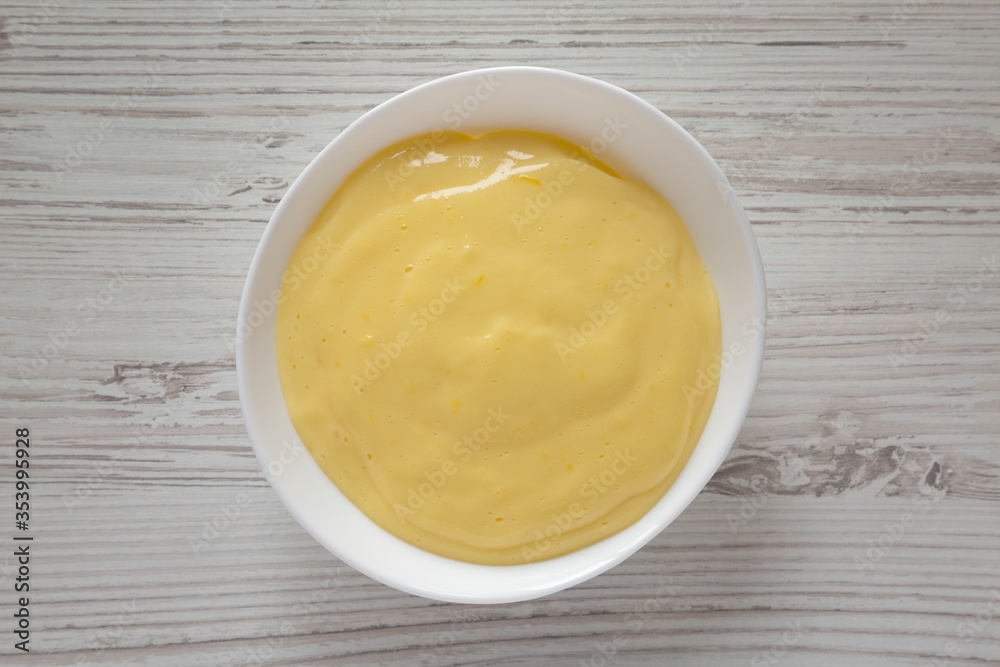 Homemade vanilla custard pudding in a white bowl, top view. Flat lay, overhead, from above. Homemade vanilla custard pudding in a white bowl, top view. Flat lay, overhead, from above.