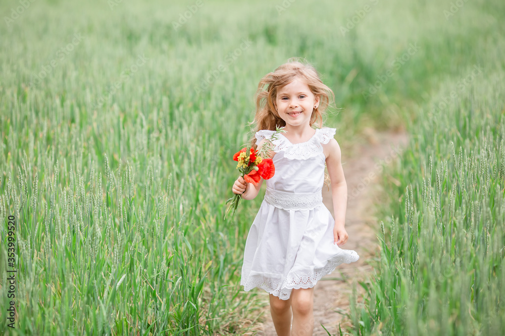 Portrait little girl blonde on at sunset in field. Little girl running in country field in summer Portrait little girl blonde on at sunset in field. Little girl running in country field in summer