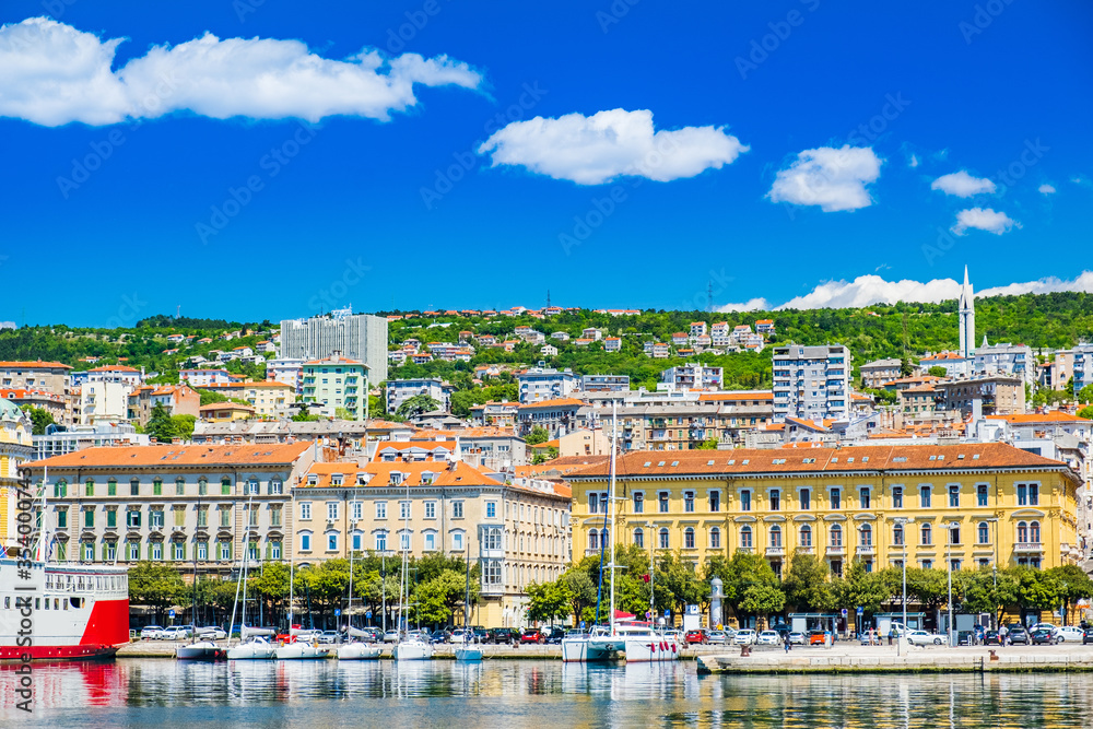 Waterfront view of the city of Rijeka, Croatia. Boats in marina and old classic monumental buildings in background.
