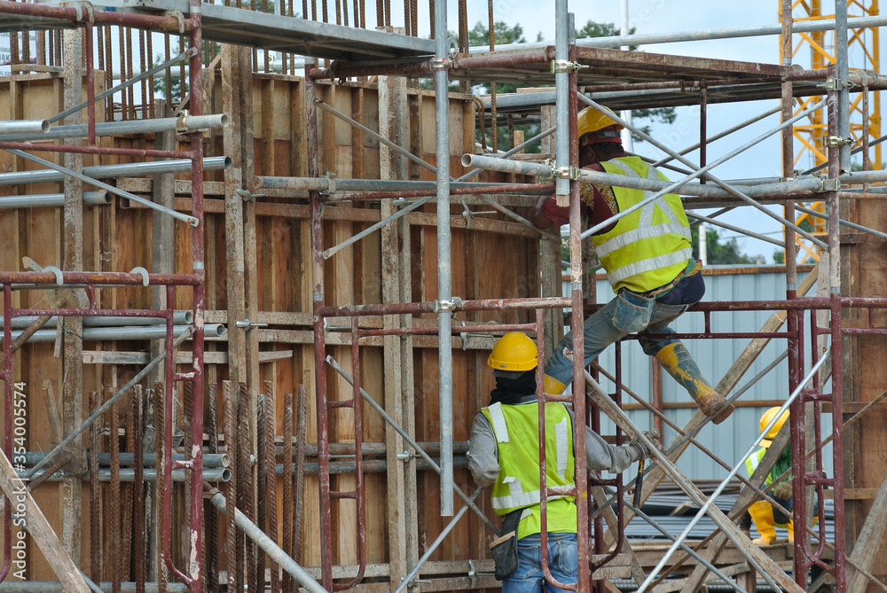 JOHOR, MALAYSIA -JUNE 30, 2016: Scaffolding used as the temporary structure to support platform, form work and structure at the construction site. Also used it as a walking platform for workers. 

