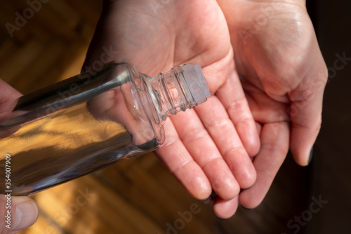 Hands open to receive eau de cologne. Turkish tradition uses KOLONYA as treatment. With Covid-19 this culture became popular. Disinfectant of 80 degrees alcohol.