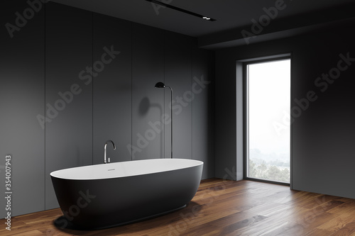 Grey bathroom corner with tub and window