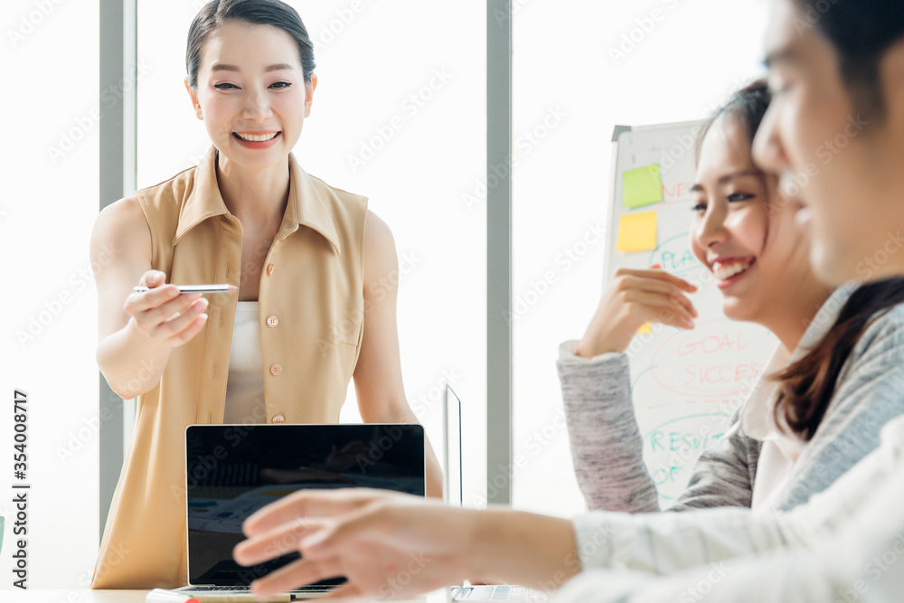 Group asian young modern people in smart casual wear having a brainstorm meeting while sitting in office background. Business presentation, Planning, Strategy, New business development,Startup concept Group asian young modern people in smart casual wear having a brainstorm meeting while sitting in office background. Business presentation, Planning, Strategy, New business development,Startup concept