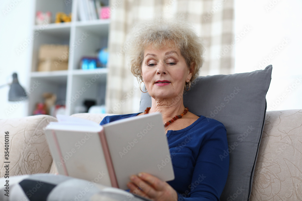 Grandmother sits at home and reads with enthusiasm Grandmother sits at home and reads with enthusiasm