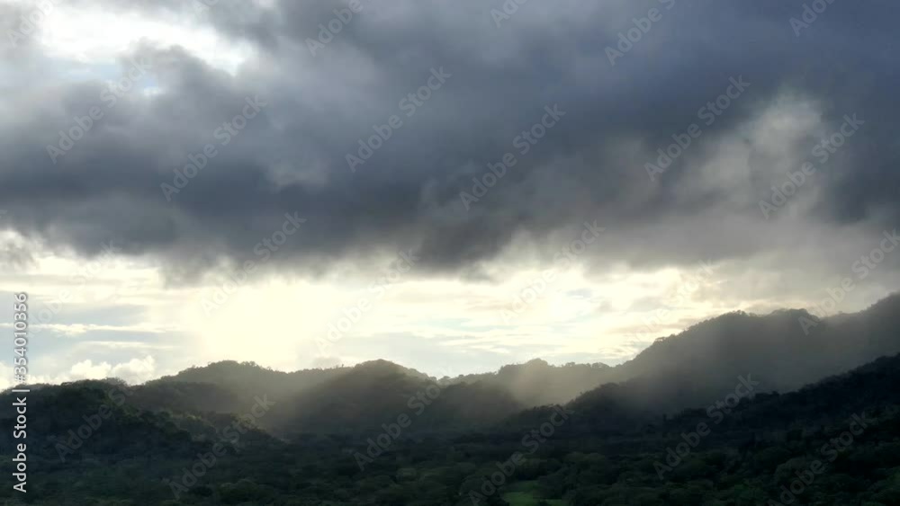 time clouds over the mountains with a sunset time clouds over the mountains with a sunset