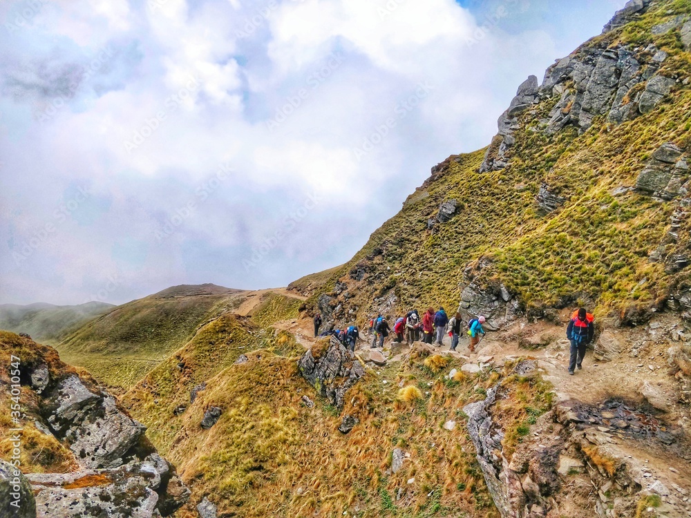 Trekking on himalayan mountain with group and a trek leader in india