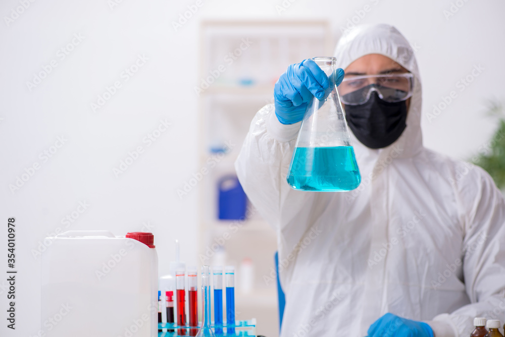 Young male chemist working in medicine lab Young male chemist working in medicine lab