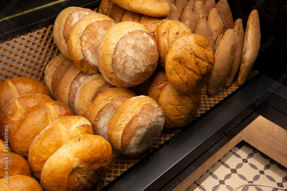 Showcase shelf with round breads in bakery. Closeup.