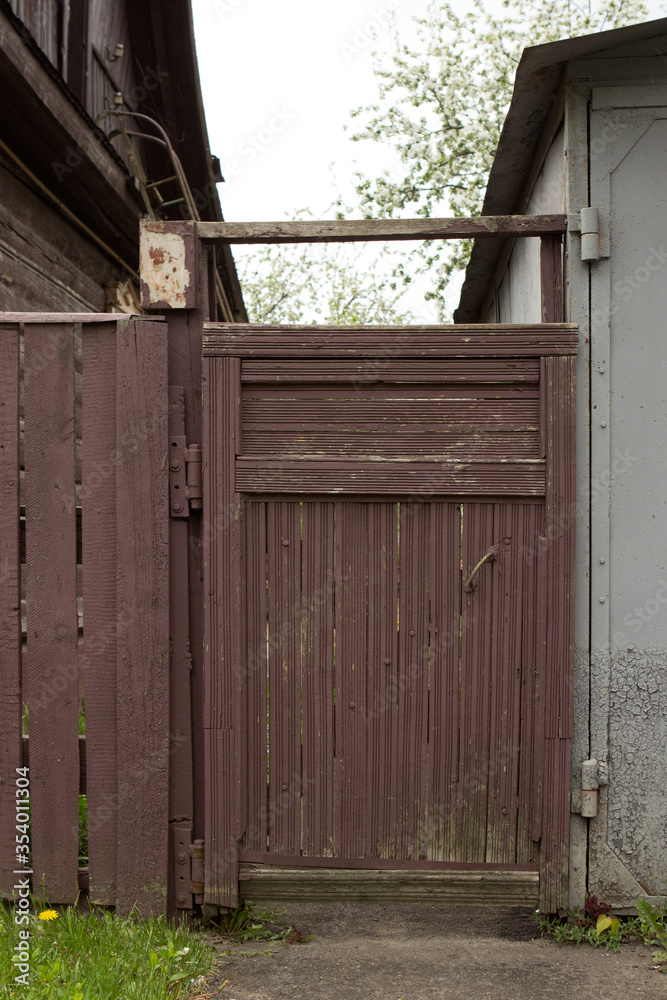 Wooden gate, entrance to a private house on a village street. Wooden gate, entrance to a private house on a village street.