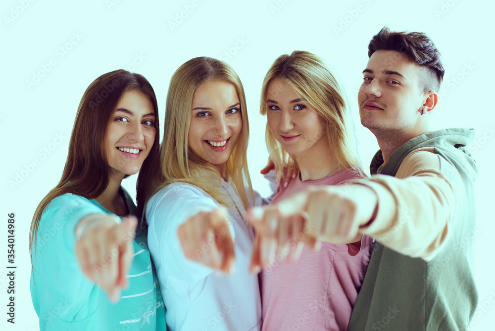Young people pointing at you standing together Young people pointing at you standing together