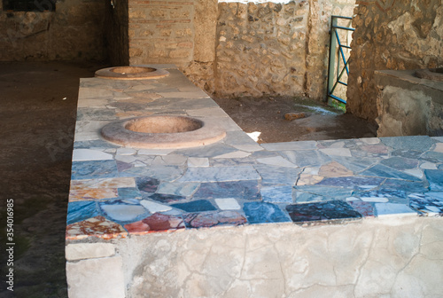 Thermopolium at Pompeii, an Ancient Roman Street Food Kitchen Serving Fast Food with Earthenware Jars called Dolia and a Counter