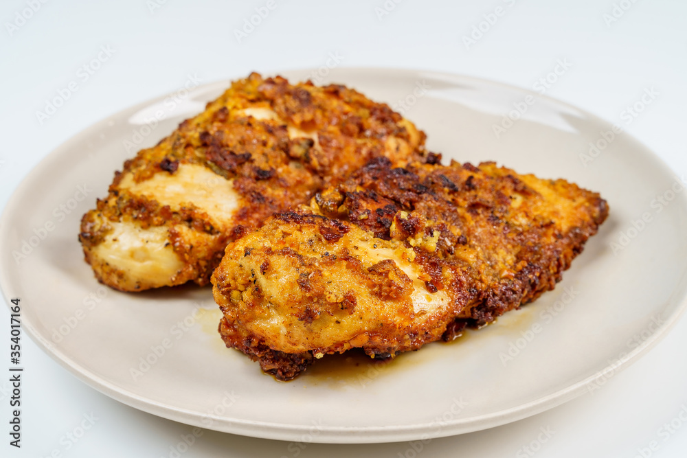 Burnt Grill Fried Chicken Breast Fillets on White Plae Isolated. Burnt Grill Fried Chicken Breast Fillets on White Plae Isolated.