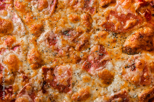 Pizza with mozzarella and salami close-up. Food background concept