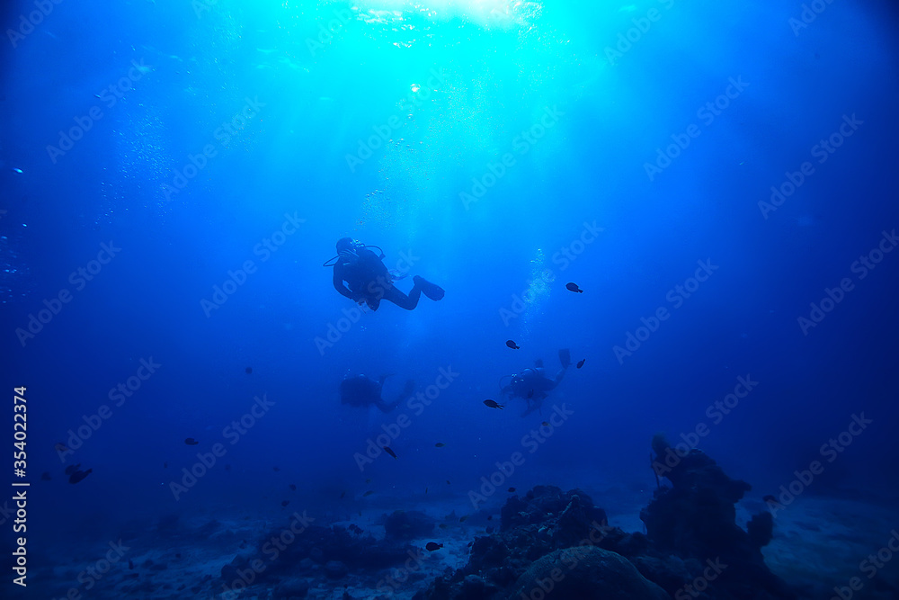 Fototapeta premium divers in the ocean, underwater sport active recreation in the deep ocean