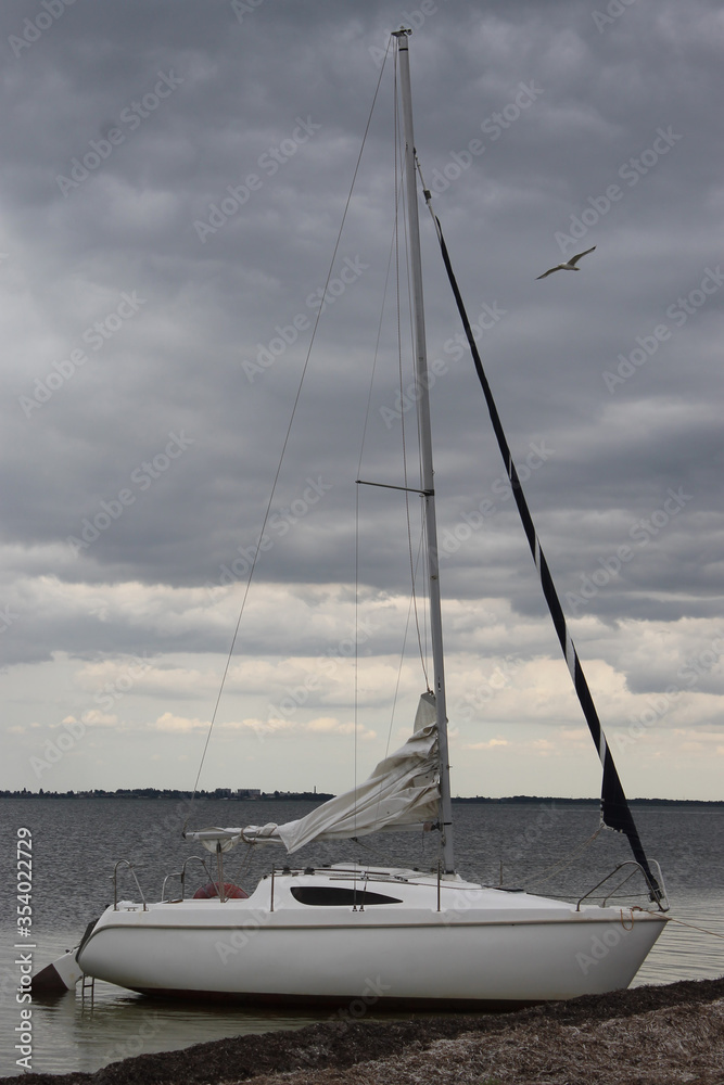 sailboat on the sea on the storm clouds background