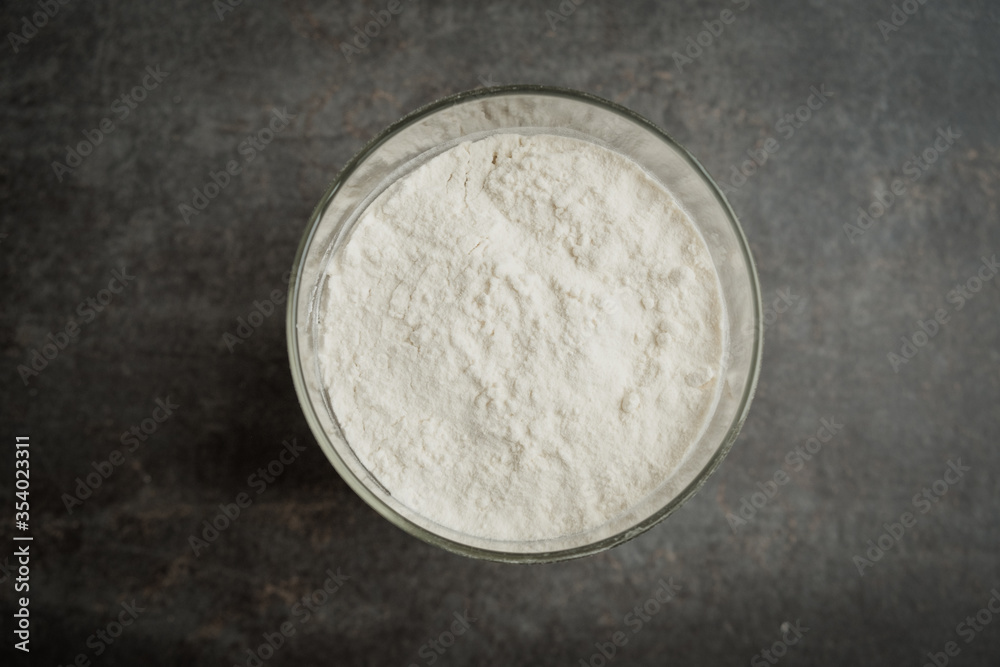Wheat flour in a glass jar on the kitchen top Wheat flour in a glass jar on the kitchen top
