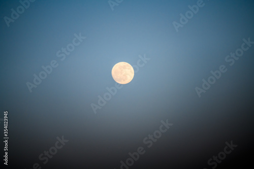 Lonely moon against a dark blue sky. Alicante province. Spain