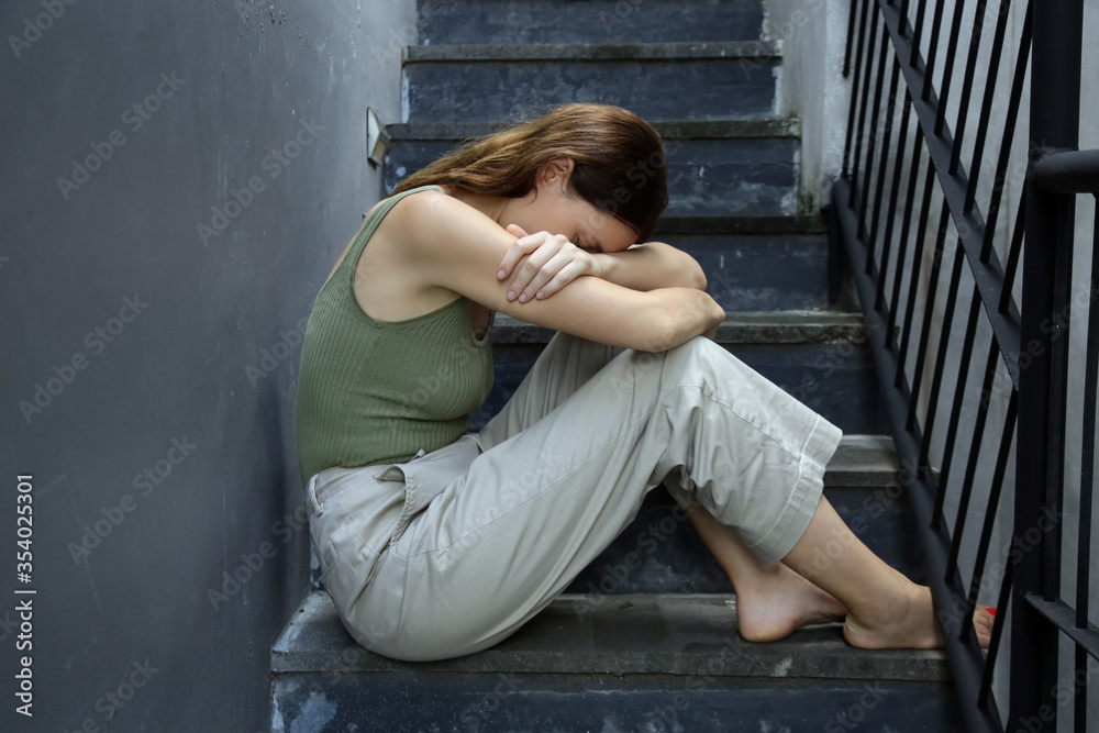 Portrait of depressed woman, covering face with her hands Portrait of depressed woman, covering face with her hands