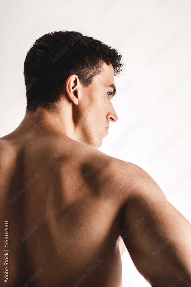 Male beauty concept. Portrait of handsome young man with stylish haircut posing over white background. Close up. Studio shot Male beauty concept. Portrait of handsome young man with stylish haircut posing over white background. Close up. Studio shot