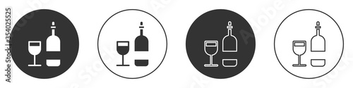 Black Wine bottle with glass icon isolated on white background. Circle button. Vector Illustration.