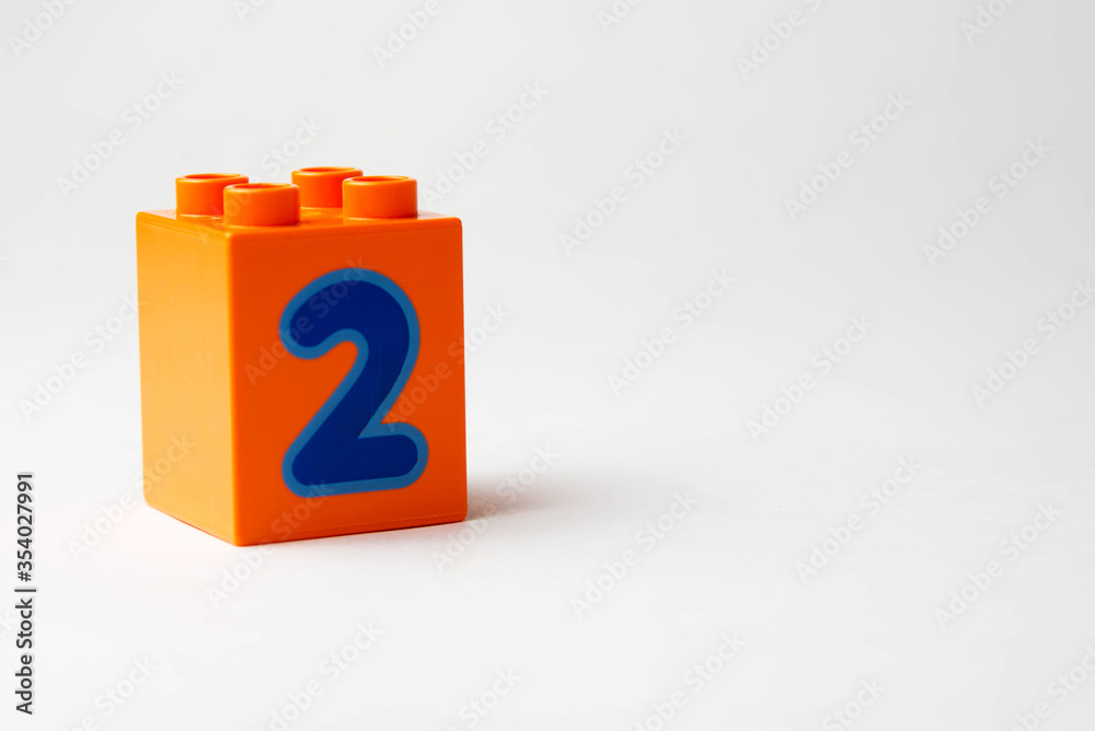 the number two written on the block from the children's constructor