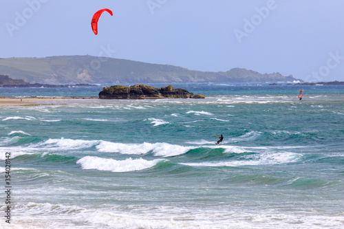 Lone Kite Surfer sailing across Mounts Bay  Marazion and photographed from the public road