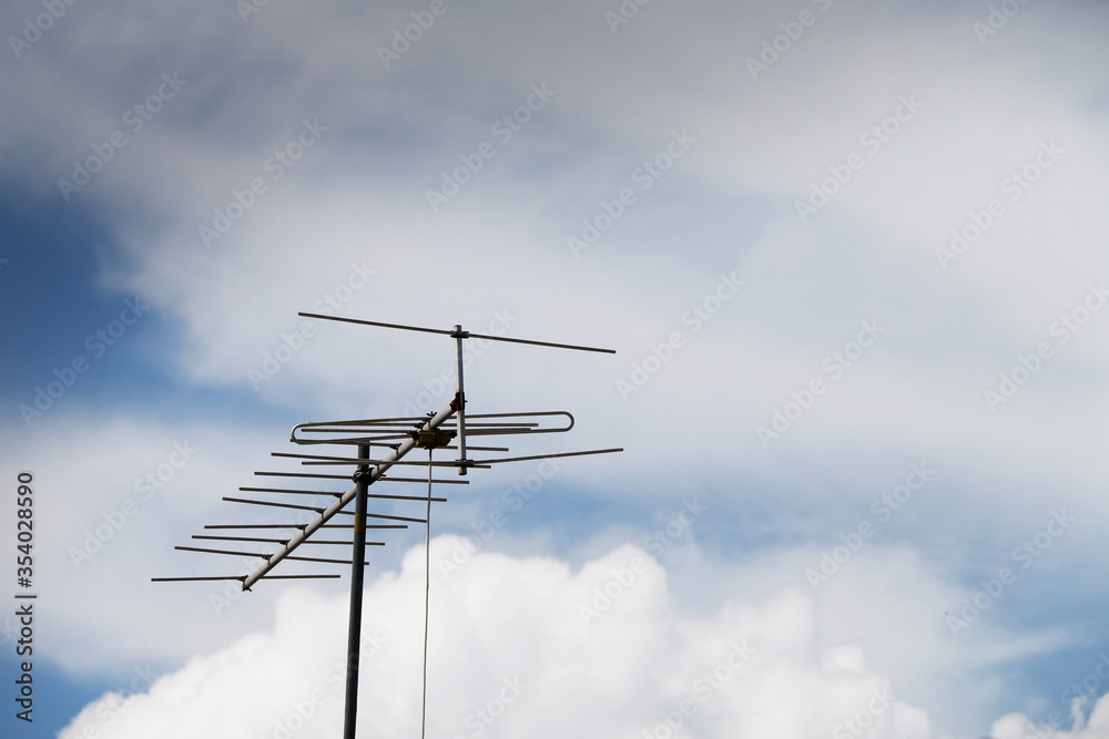 TV antenna on a background cloudy sky TV antenna on a background cloudy sky